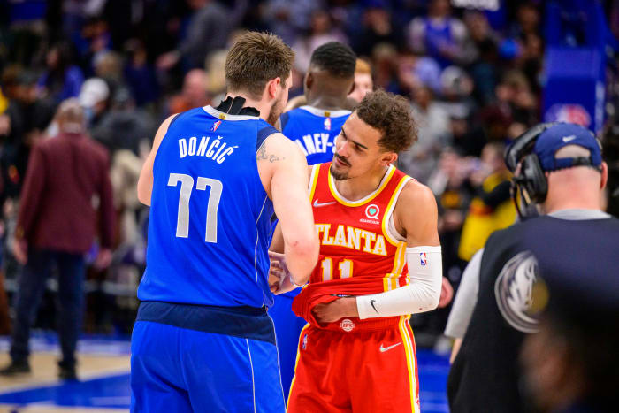 Mavericks guard Luka Doncic shakes hands with Hawks guard Trae Young.